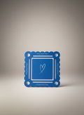 Bobbie's Shoppe blue mahjong pool mat with white bottom and heart graphic. Scalloped edges with text.